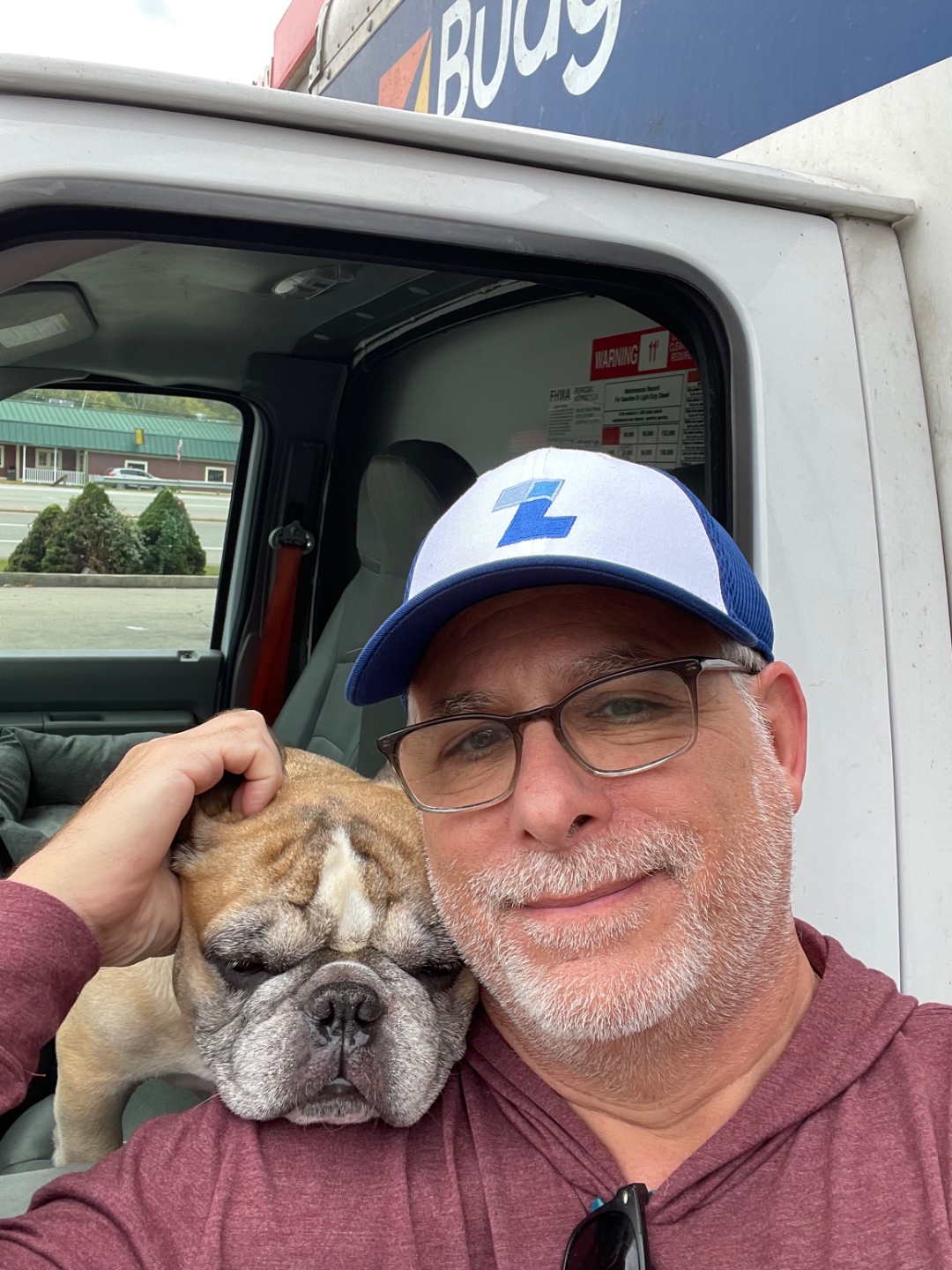Lane Yago and Boo Radley in a rental truck cab, on a road trip together.